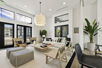 a living room with a couch and chairs and a table